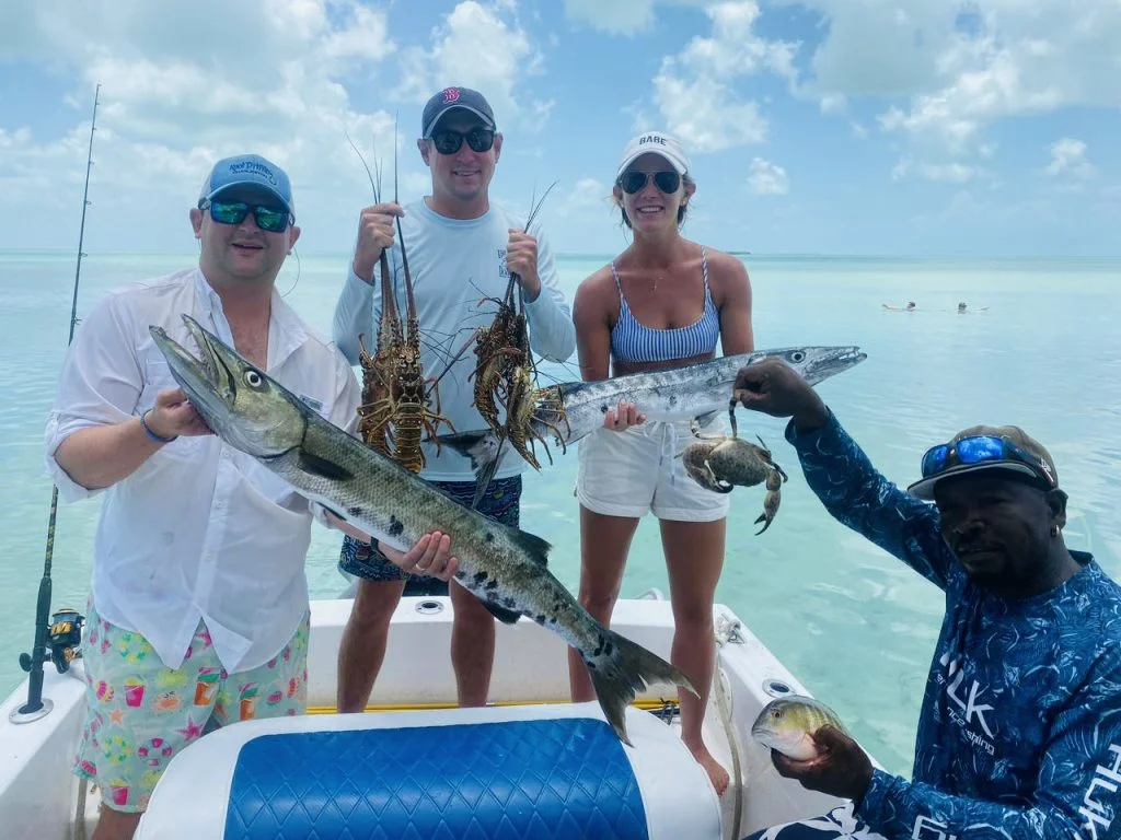 Guests and guide celebrating a fresh catch aboard Seakarus